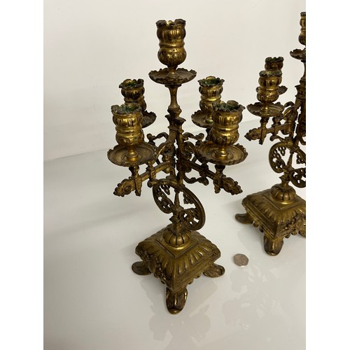 177 - A pair of ornate cast  brass four branch candlelabras.

This lot is available for in house shipping ... 