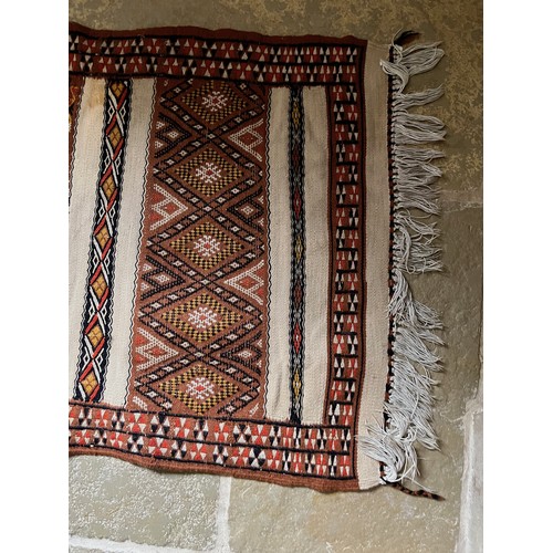 32 - A hand tied floor rug with a geometric design, 2 metres x 70 cm wide.

This lot is available for in-... 