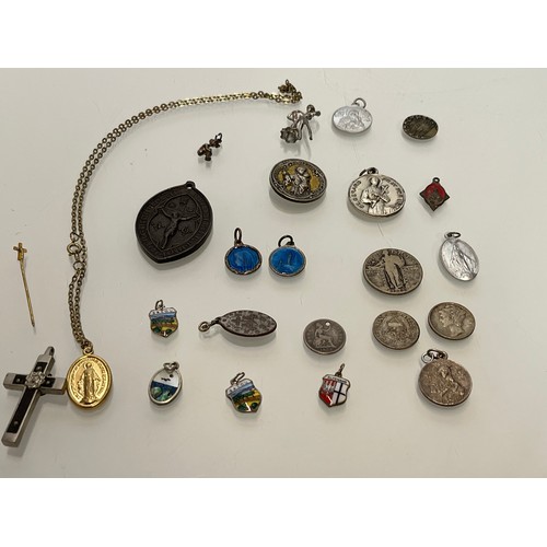 503 - A collection of charms pendants and coins.

This lot is available for in-house shipping