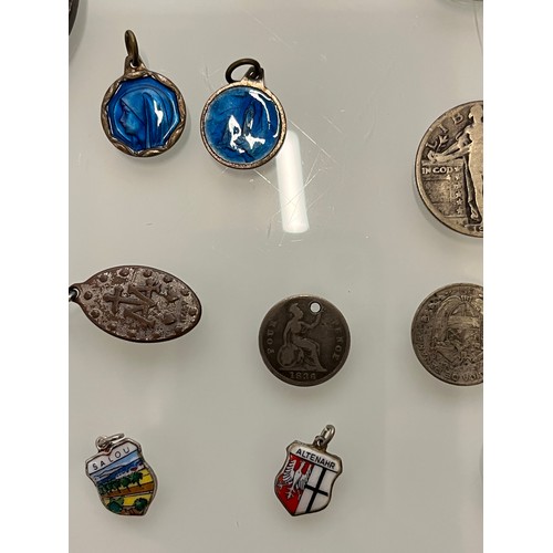 503 - A collection of charms pendants and coins.

This lot is available for in-house shipping