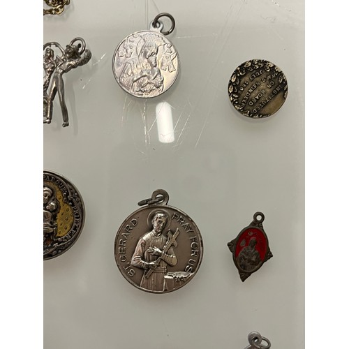 503 - A collection of charms pendants and coins.

This lot is available for in-house shipping