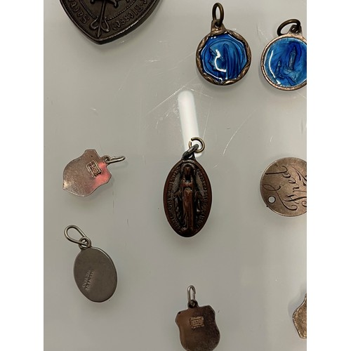 503 - A collection of charms pendants and coins.

This lot is available for in-house shipping