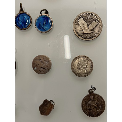 503 - A collection of charms pendants and coins.

This lot is available for in-house shipping