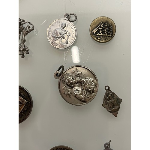 503 - A collection of charms pendants and coins.

This lot is available for in-house shipping