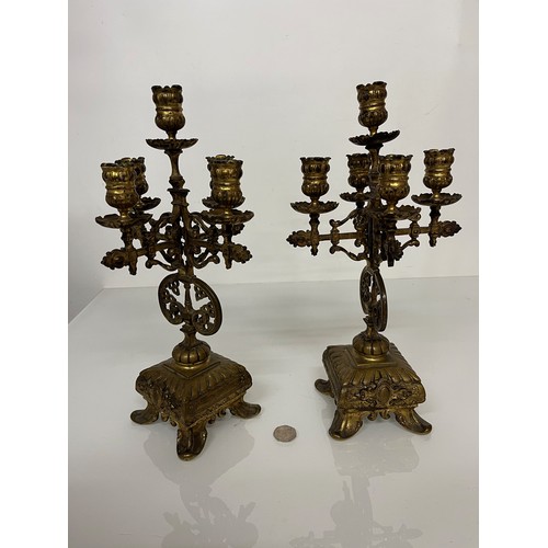 195 - A pair of ornate cast  brass four branch candlelabras.

This lot is available for in house shipping ... 