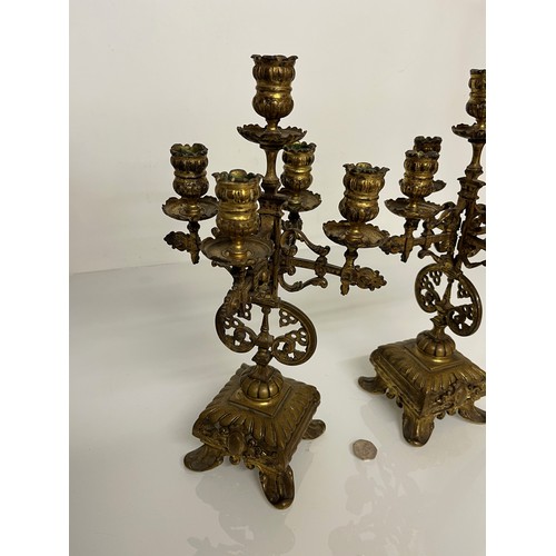 195 - A pair of ornate cast  brass four branch candlelabras.

This lot is available for in house shipping ... 