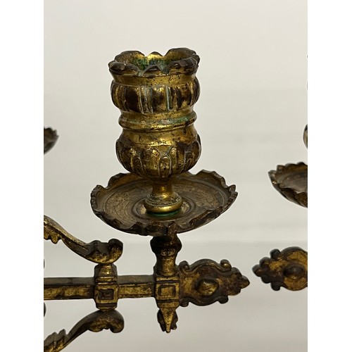 195 - A pair of ornate cast  brass four branch candlelabras.

This lot is available for in house shipping ... 