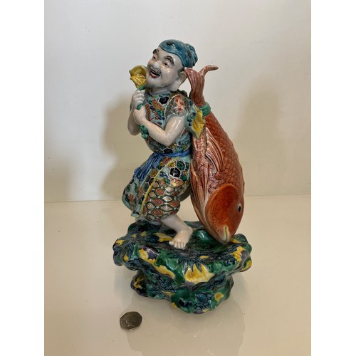 202 - Oriental figure of a Fisherman, 32 cm high.

This lot is available for in-house shipping