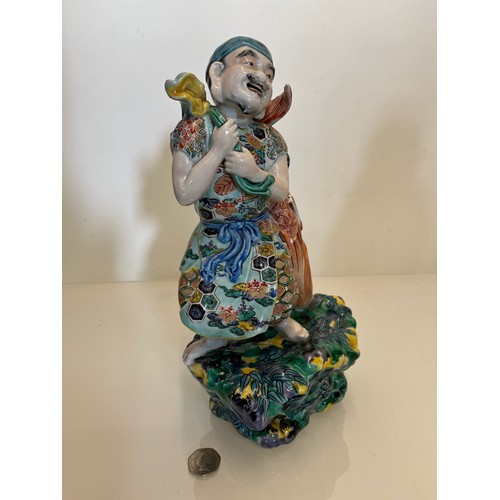 202 - Oriental figure of a Fisherman, 32 cm high.

This lot is available for in-house shipping