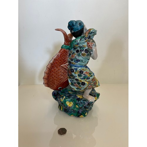 202 - Oriental figure of a Fisherman, 32 cm high.

This lot is available for in-house shipping