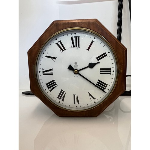 205 - A 12 inch double sided GPO hanging clock with a fusee movement. Features a fully serviced and cleane... 