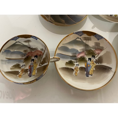 417 - Decorative Japanese tea set with scenes incorporating Mount Fuji, tea pot, sugar bowl and 12 cups an... 