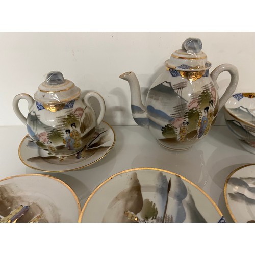 417 - Decorative Japanese tea set with scenes incorporating Mount Fuji, tea pot, sugar bowl and 12 cups an... 