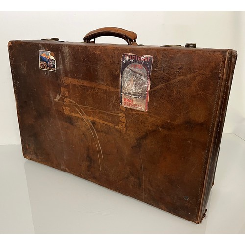 383 - Early C20th luggage, a leather suitcase marked for Selfridge London, with travel label illustrated w... 