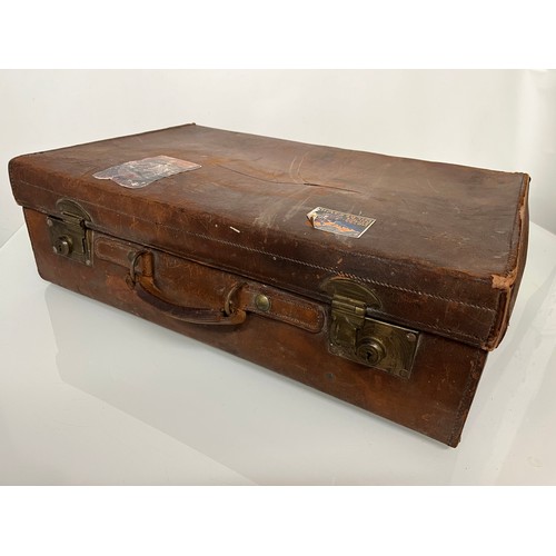 383 - Early C20th luggage, a leather suitcase marked for Selfridge London, with travel label illustrated w... 