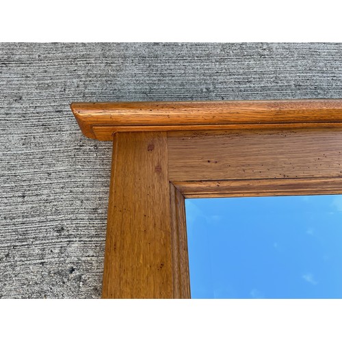 348 - A very large oak framed bevel edged wall mirror 220 cm long 101 cm high.

This lot is collection onl... 