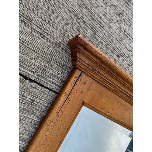 348 - A very large oak framed bevel edged wall mirror 220 cm long 101 cm high.

This lot is collection onl... 