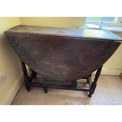 367 - C19th drop leaf circular topped dinning table with carved decoration.

This lot is collection only