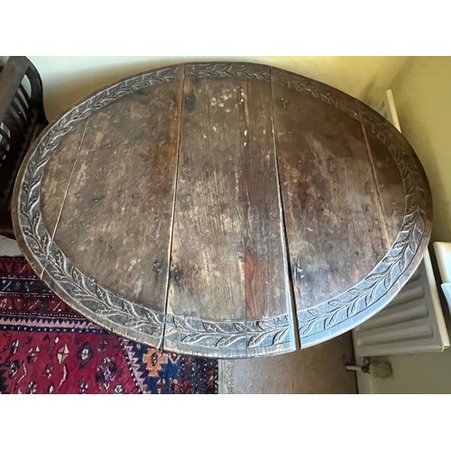 367 - C19th drop leaf circular topped dinning table with carved decoration.

This lot is collection only