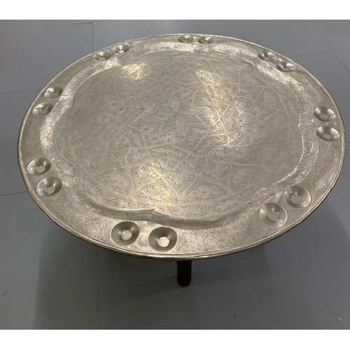 370 - Furniture, North African folding table with 76 cm diameter top with embobbed and carved designs.