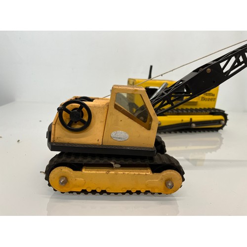 52 - Tonka toys, tinplate models a tracked crane and a bulldozer.

This lot is available for in-house shi... 