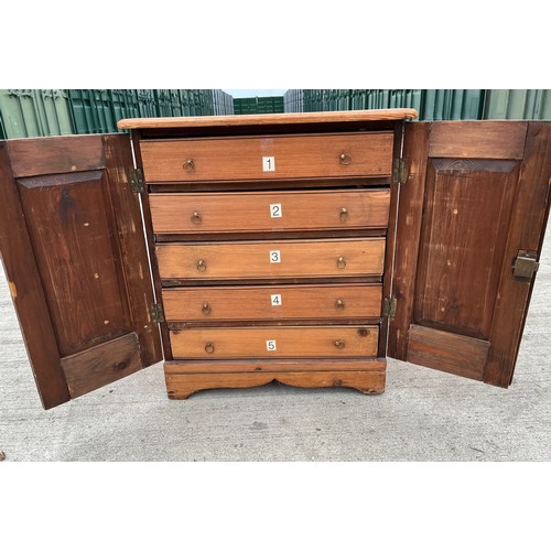 93 - Pine collectors cabinet five drawer sections behind two doors. 45 x 39 cm x 52 cm high.

This lot is... 