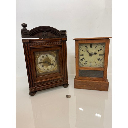 99 - Two early C20th wooden cased mantle clocks.

This lot is available for in-house shipping