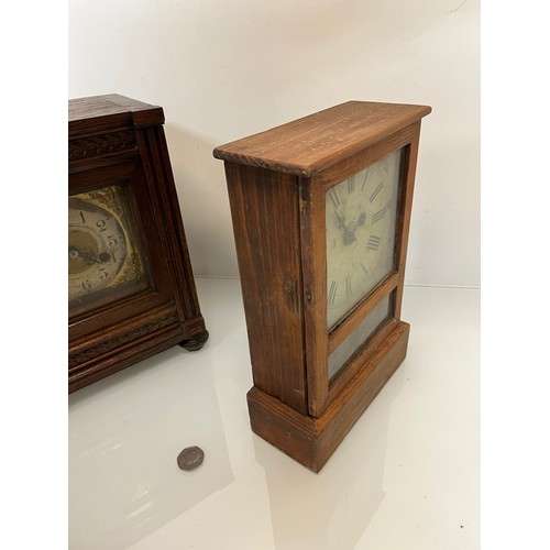 99 - Two early C20th wooden cased mantle clocks.

This lot is available for in-house shipping