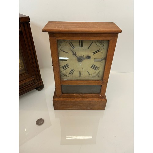 99 - Two early C20th wooden cased mantle clocks.

This lot is available for in-house shipping