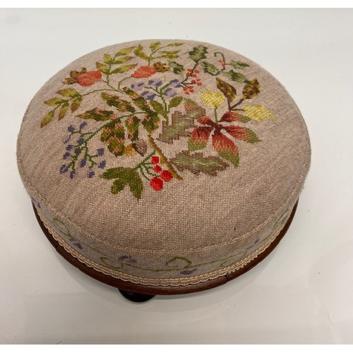 105 - Antique furniture, a circular foot stool with decorative needlework  top and sides, 12 inches in dia... 