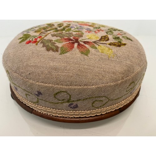 105 - Antique furniture, a circular foot stool with decorative needlework  top and sides, 12 inches in dia... 