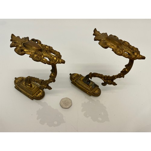 110 - Pair of Brass curtain tie backs the finials are 10cm high.

This lot is available for in-house shipp... 