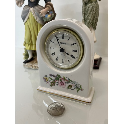 119 - Mixed items, a ceramic cased clock and three figurines.

This lot is available for in-house shipping