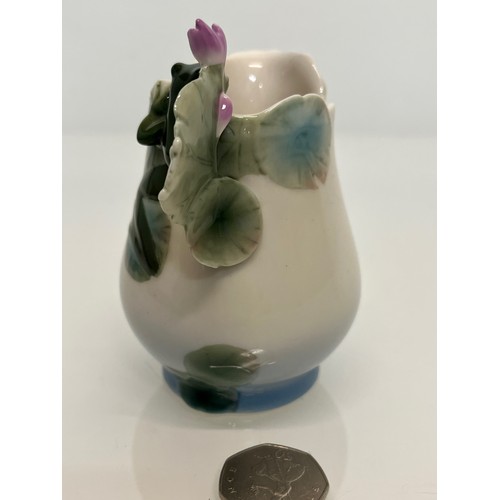 134 - Franz pottery, a Jug with floral decoration. 

This lot is available for in-house shipping