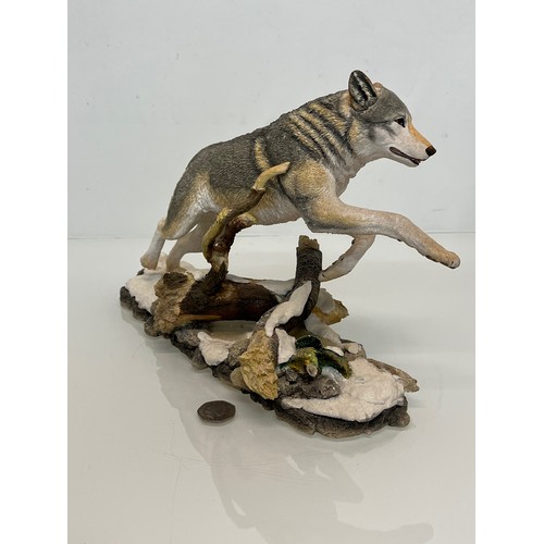 138 - A figurine of a leaping Wolf, 36 cm long, 23 cm high.

This lot is available for in-house shipping