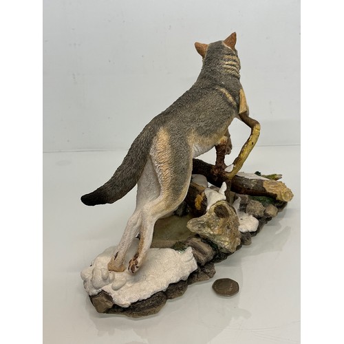 138 - A figurine of a leaping Wolf, 36 cm long, 23 cm high.

This lot is available for in-house shipping