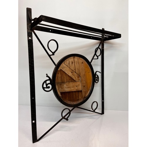 305 - An Arts and Crafts wrought iron hall unit, hat and coat rail with circular bevel edged mirror to the... 