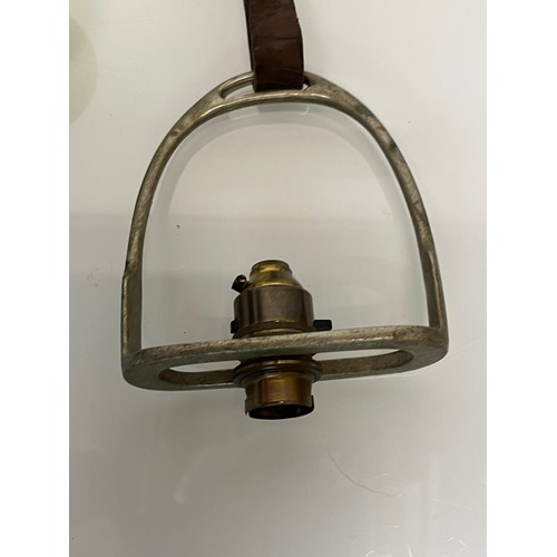 197 - Equestrian interest, an adjustable hanging light fitting within a stirrup.

This lot is available fo... 