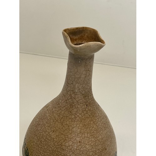 199 - Stoneware bottle with crackle glaze and hand decorated with flowers.

This lot is available for in-h... 