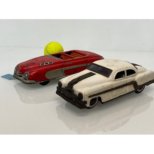 208 - Two tinplate toy cars, a friction dive two door saloon and a lithographed open topped roadster by Ma... 