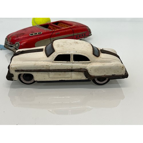 208 - Two tinplate toy cars, a friction dive two door saloon and a lithographed open topped roadster by Ma... 