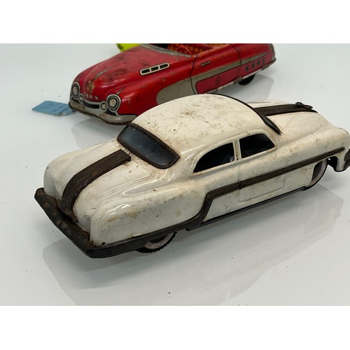 208 - Two tinplate toy cars, a friction dive two door saloon and a lithographed open topped roadster by Ma... 