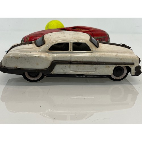 208 - Two tinplate toy cars, a friction dive two door saloon and a lithographed open topped roadster by Ma... 