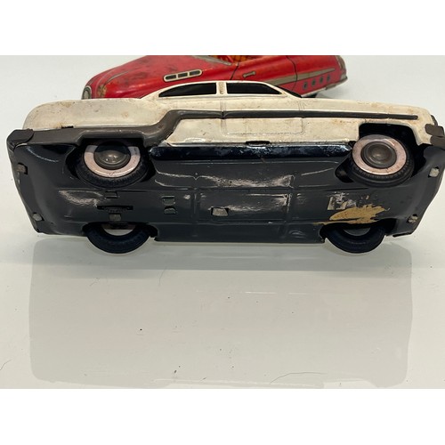 208 - Two tinplate toy cars, a friction dive two door saloon and a lithographed open topped roadster by Ma... 