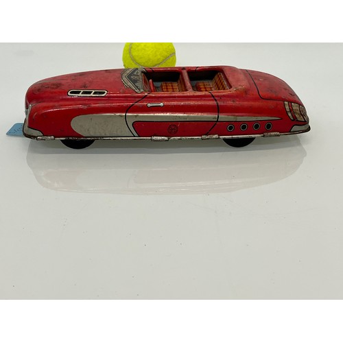 208 - Two tinplate toy cars, a friction dive two door saloon and a lithographed open topped roadster by Ma... 