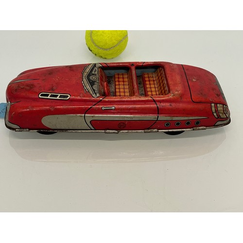 208 - Two tinplate toy cars, a friction dive two door saloon and a lithographed open topped roadster by Ma... 