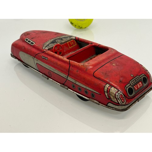 208 - Two tinplate toy cars, a friction dive two door saloon and a lithographed open topped roadster by Ma... 