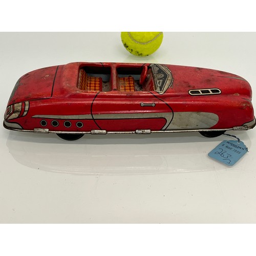 208 - Two tinplate toy cars, a friction dive two door saloon and a lithographed open topped roadster by Ma... 