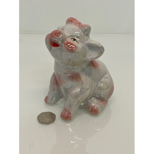 222 - A lustre glazed money box in the form of a seated pig.


This lot is available for in-house shipping