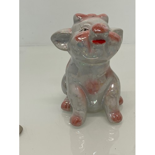 222 - A lustre glazed money box in the form of a seated pig.


This lot is available for in-house shipping